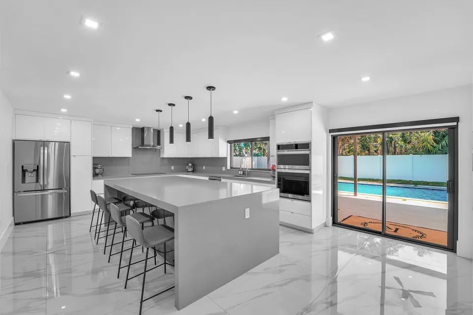 Chef's kitchen with custom island and pool view