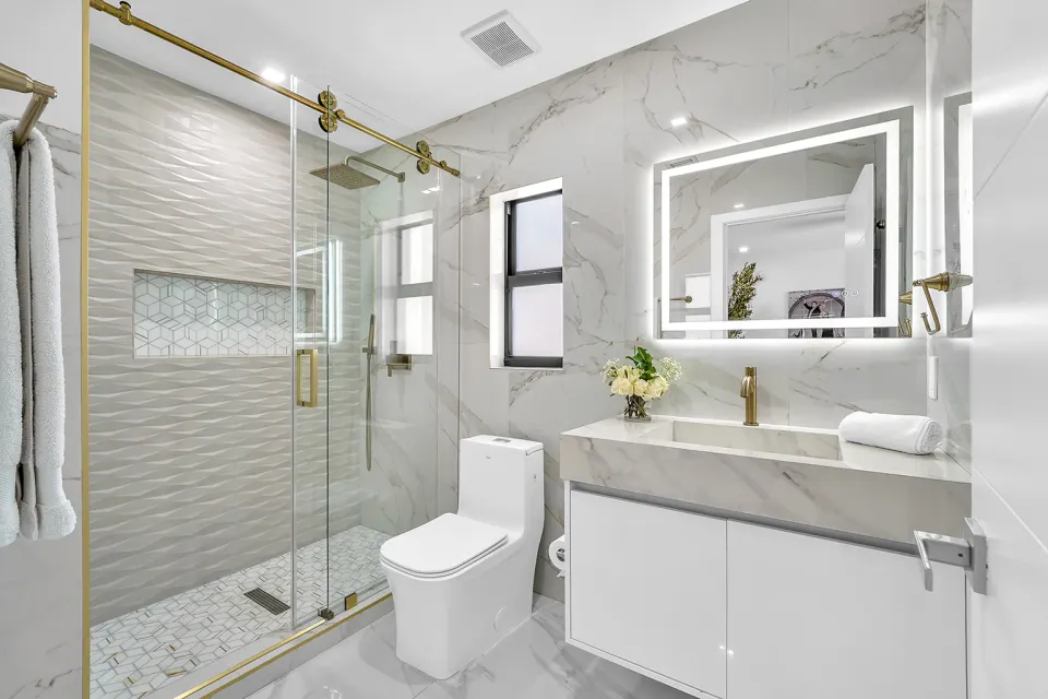 Spa bathroom with gold fixtures and marble
